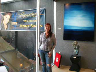 Jenny Simon at The Signature Gallery in front of JS Banner